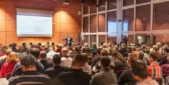 A large crowd of people in an auditorium.