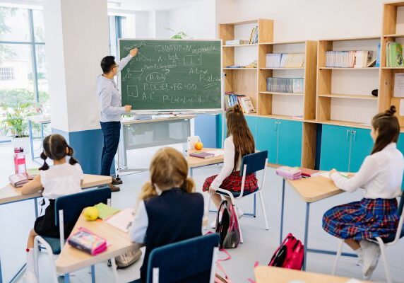 Math MileMarkers® A classroom with students in the desks and a teacher.